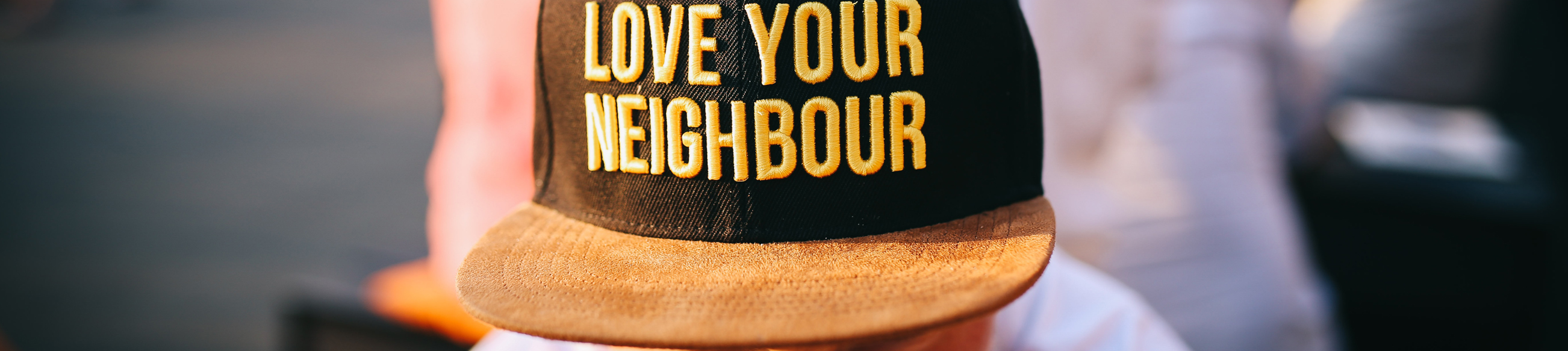 A hat with the words Love Your Neighbor.