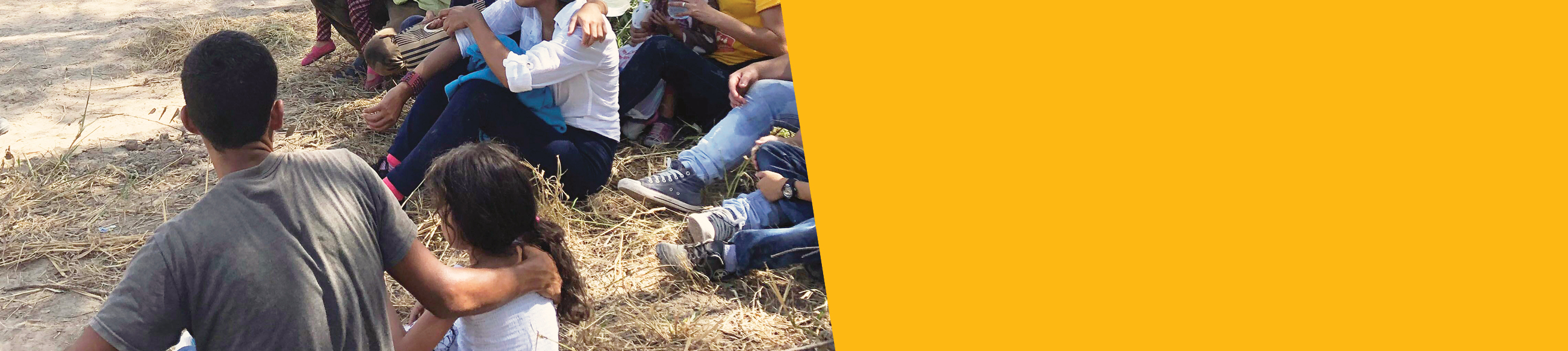People sitting in the shade with their children