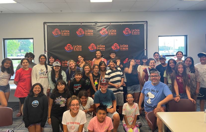 Participants in La Casa de Amistad's youth programs, with Humberto Delgado, assistant executive director and director of youth programs, bottom right.