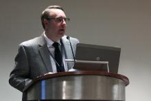 A man stands and speaks at a podium