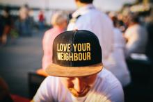 Man with hat that says love your neighbor