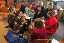 People sitting in a circle discussion an issue.