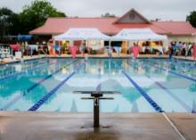 A swimming pool with people in the background.