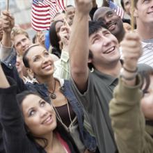 People holding flags at a rally.