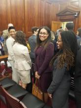 A woman smiles in a courtroom.