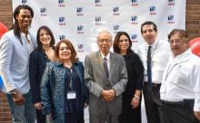 Seven people standing in front of IACO background