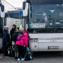 A picture of people getting on a bus.